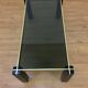 Italian coffee table from the 70s, smoked glass, black and gold lacquered wood.
