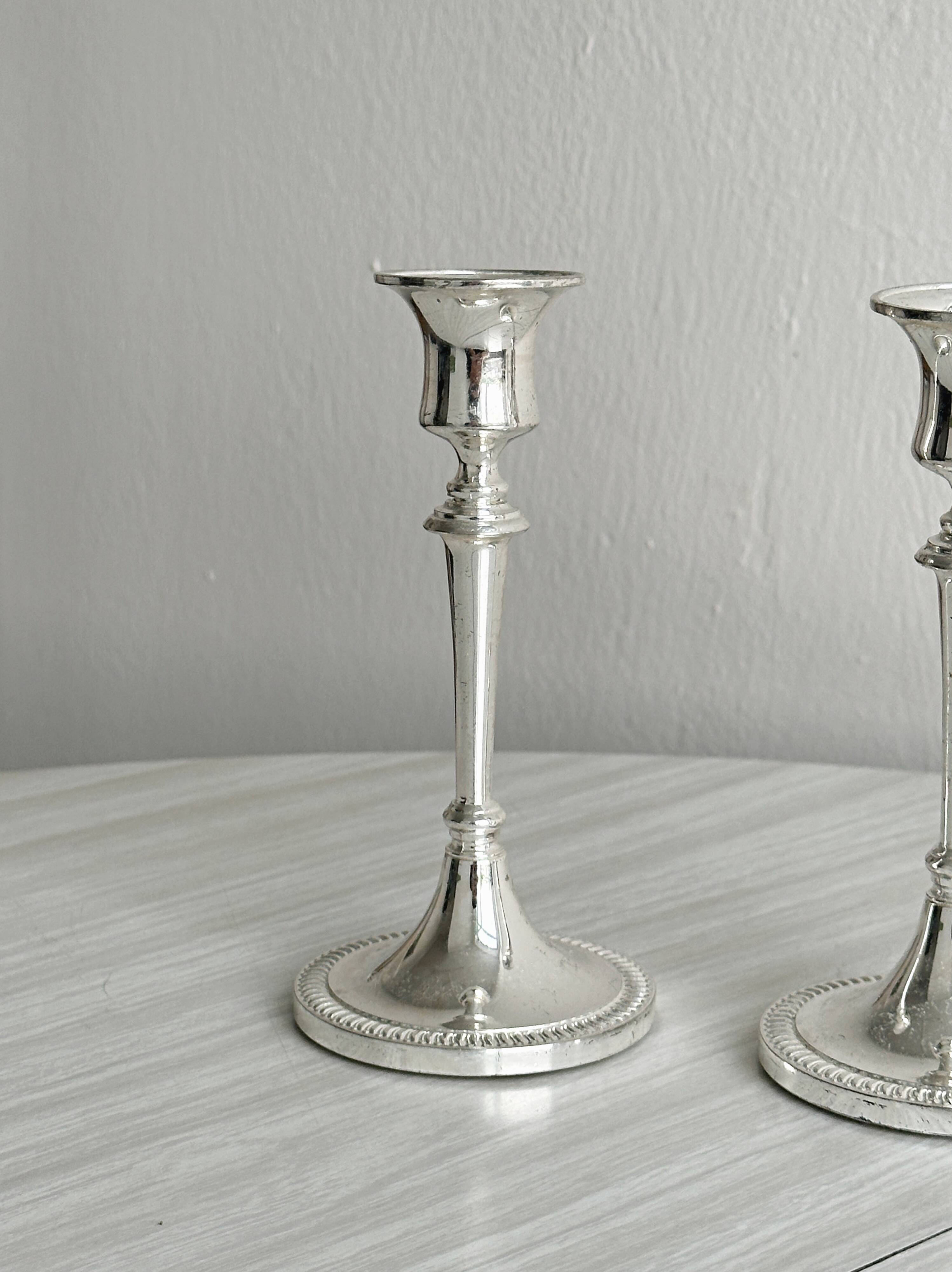 Pair of white metal candlesticks