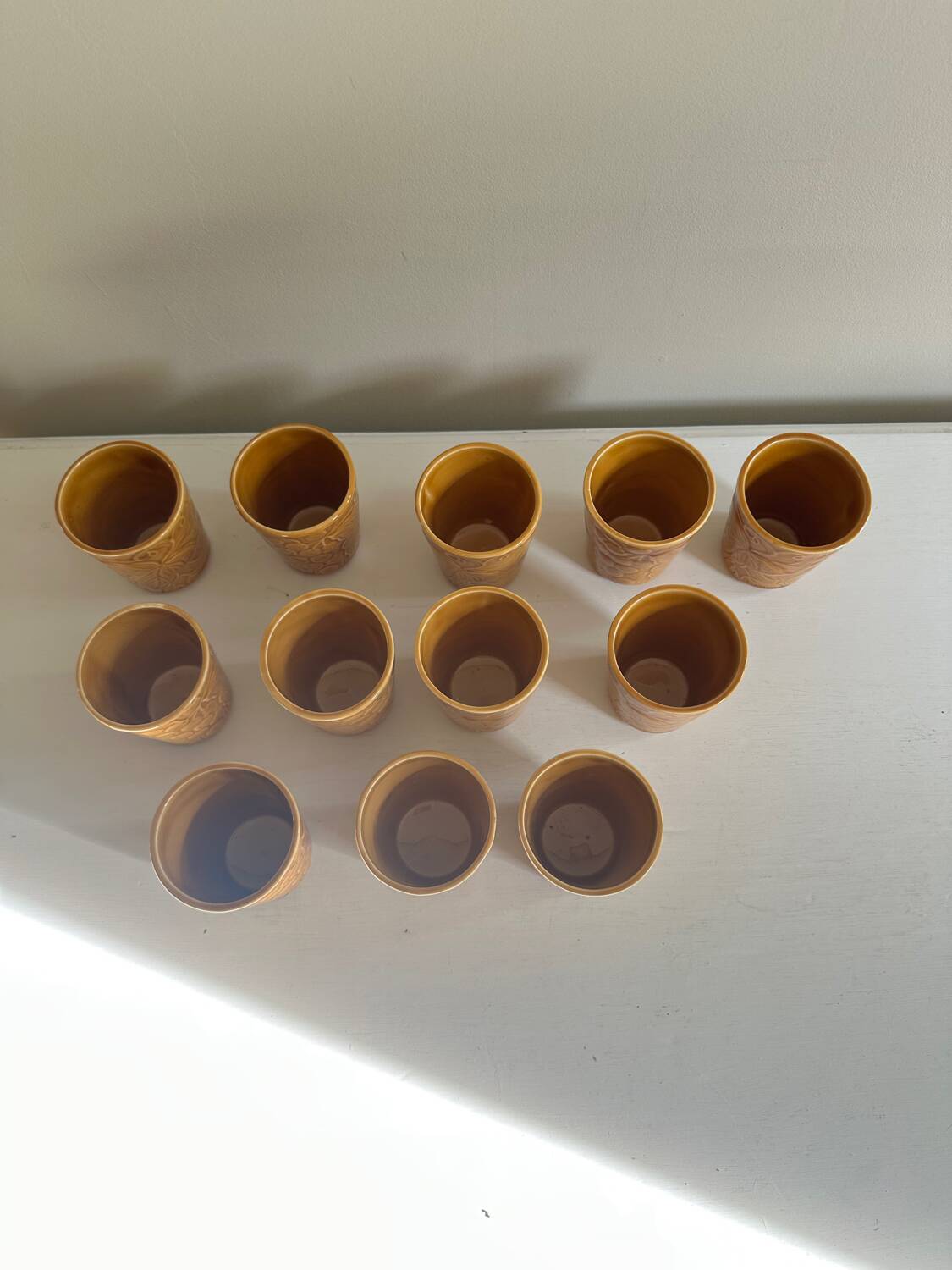 Set of 12 ochre Chavaillon de Sarreguemines cups
