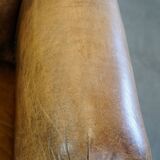Fauteuil ancien en cuir de mouton