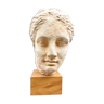 Plaster head of an ancient goddess on its wooden base