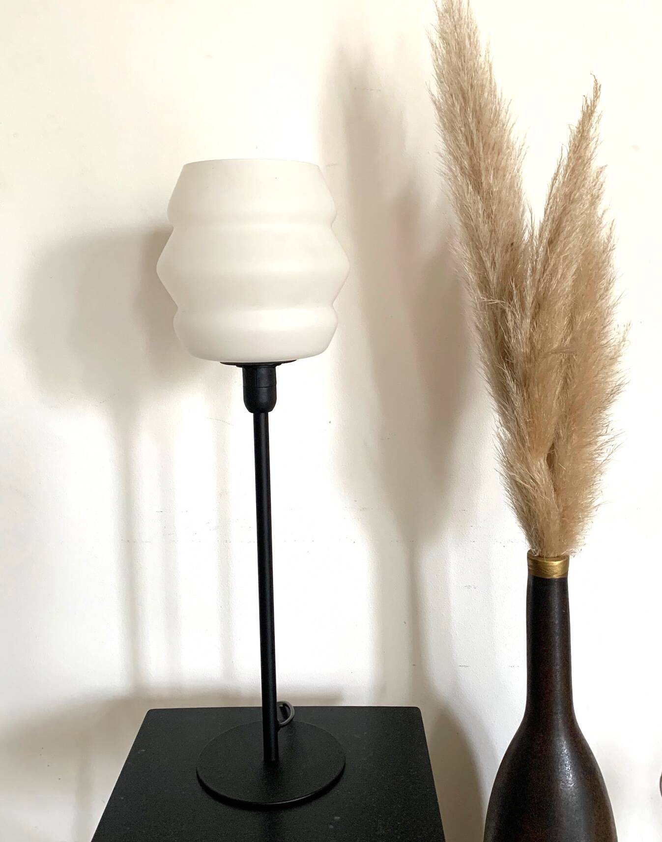 Table lamp with a vintage white glass globe and a golden base