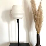 Table lamp with a vintage white glass globe and a golden base