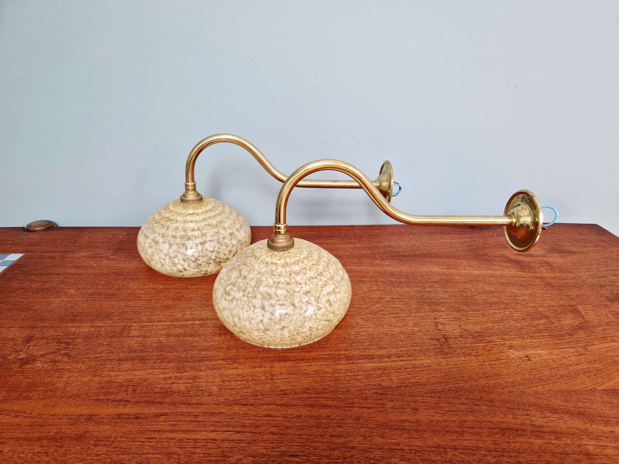 Pair of brass and yellow/white speckled glass wall sconces