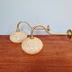 Pair of brass and yellow/white speckled glass wall sconces