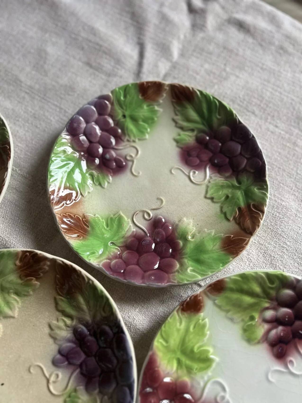 Set of eight flat dessert plates in barbotine earthenware with grape decoration – circa 1900.