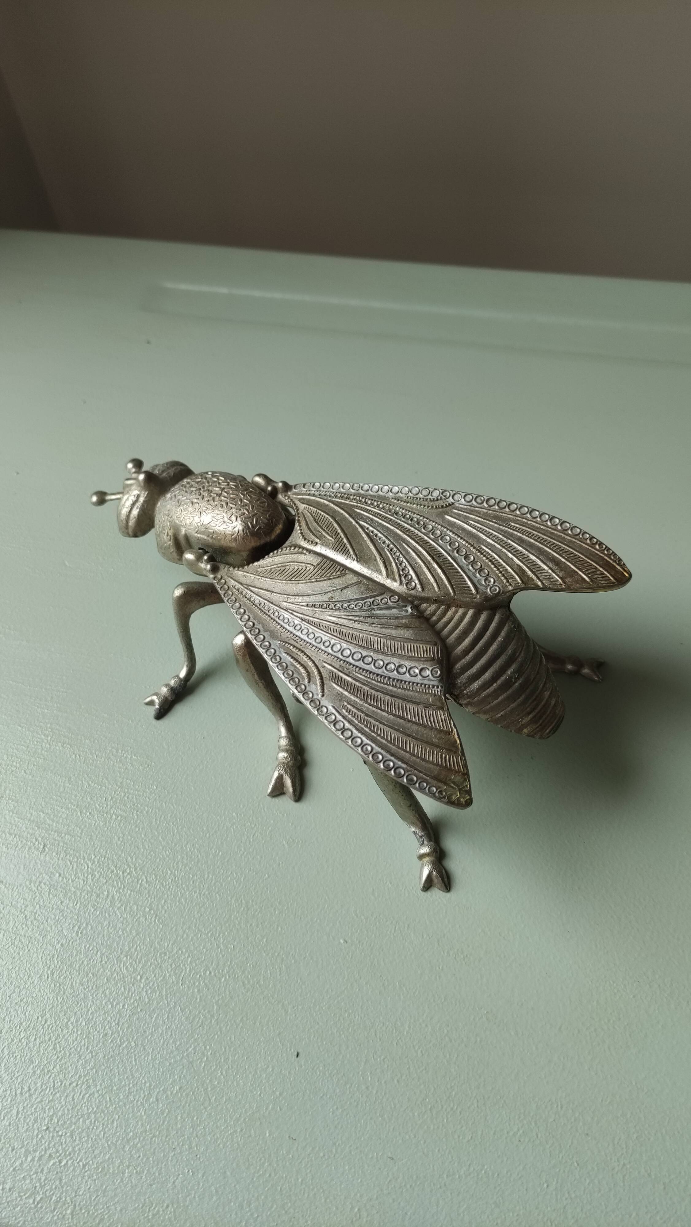 Vintage metal fly, old ashtray to divert