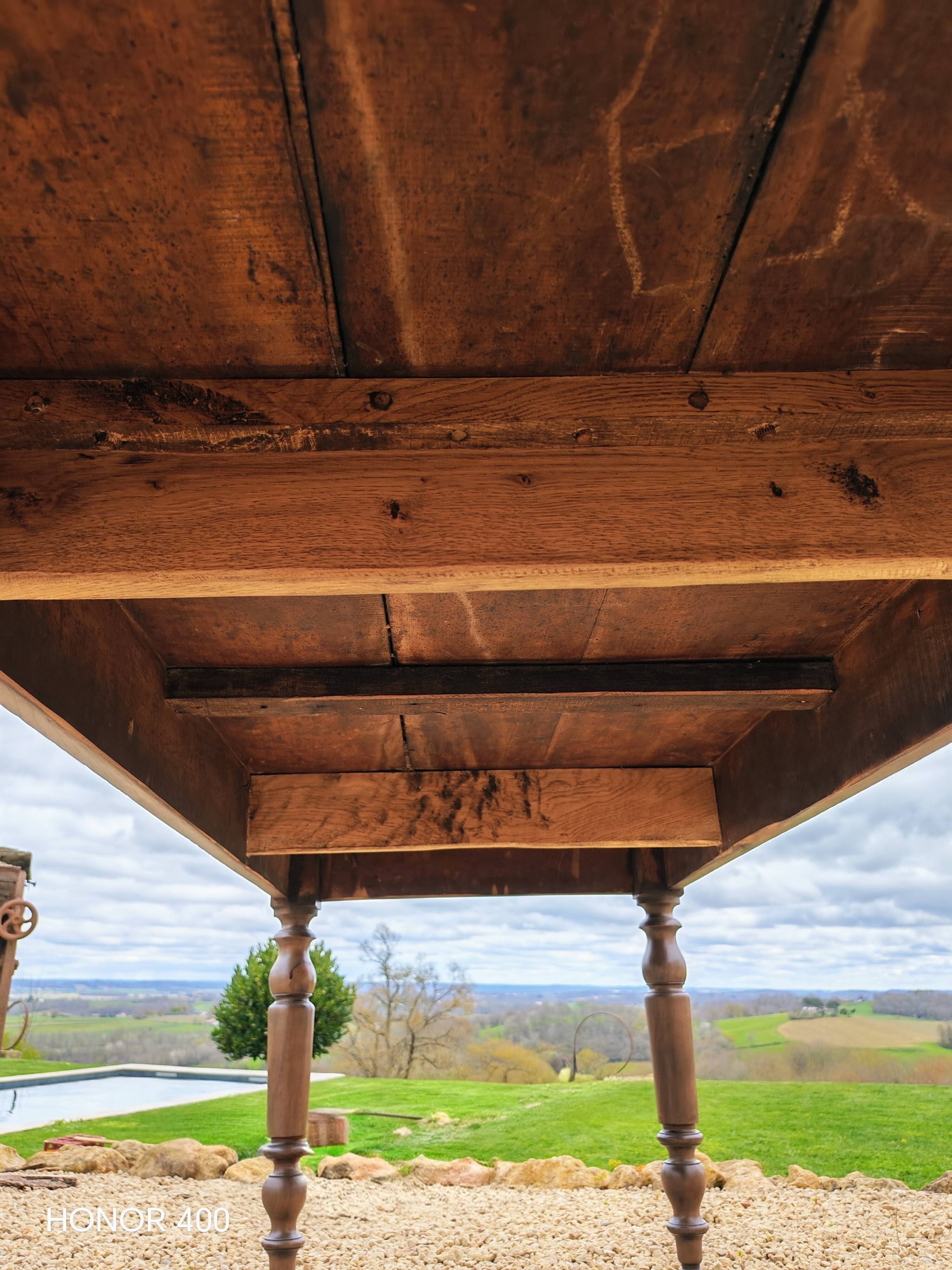 Old French farmhouse table in walnut with turned legs.
