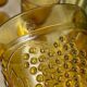Six amber-colored stemmed glasses