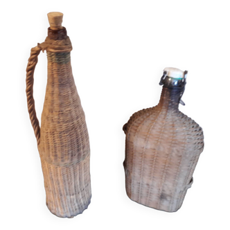 Set of two glass and wicker bottles