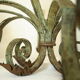 Lustre 8 branches en fer forgé patine gris de vert  et dorure ancien