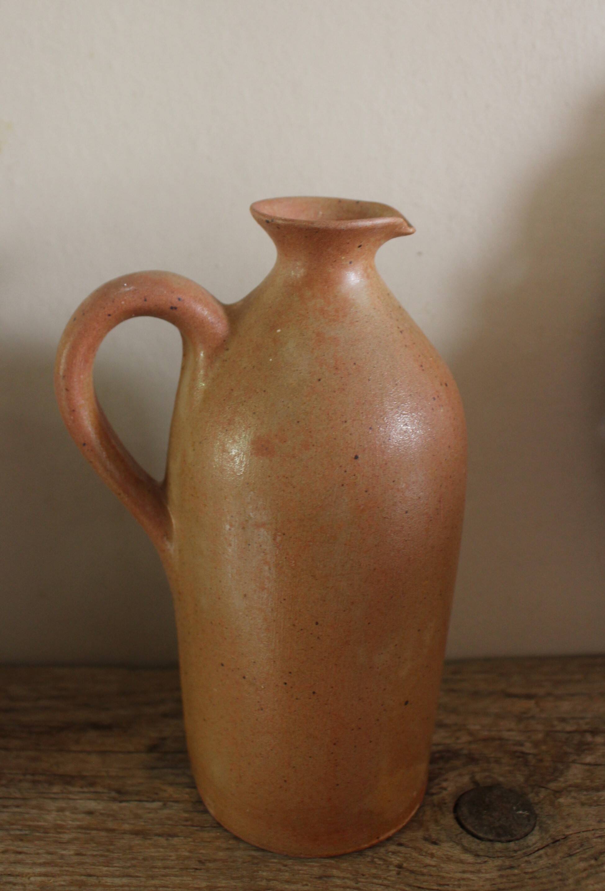 Vintage stoneware liqueur bottle with handle