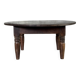 Coffee table, round antique Indonesian teak table with straight legs.