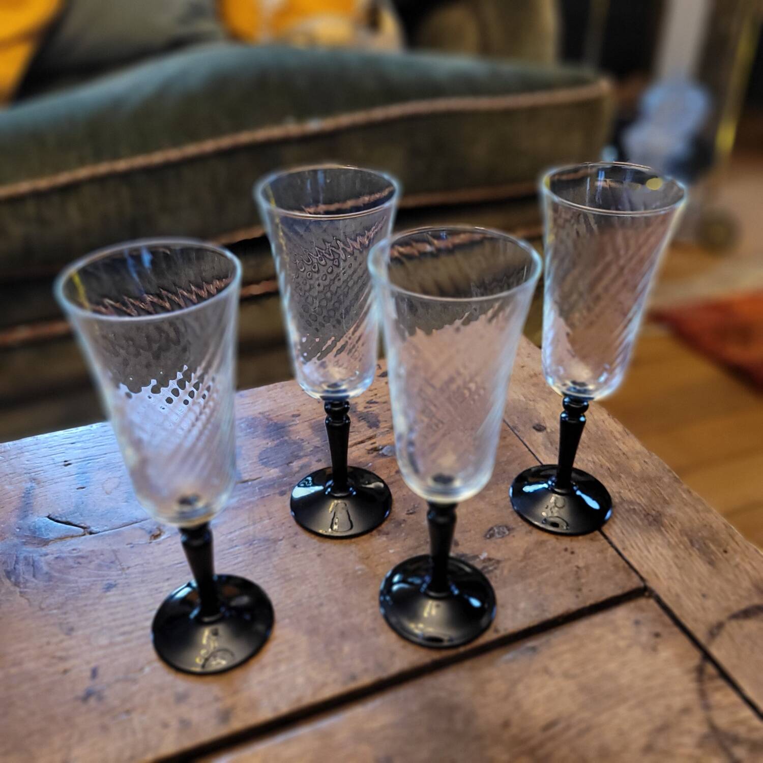 4 clear glass flutes with black stems. 1960–1970. 4 clear glass flutes with black stems.