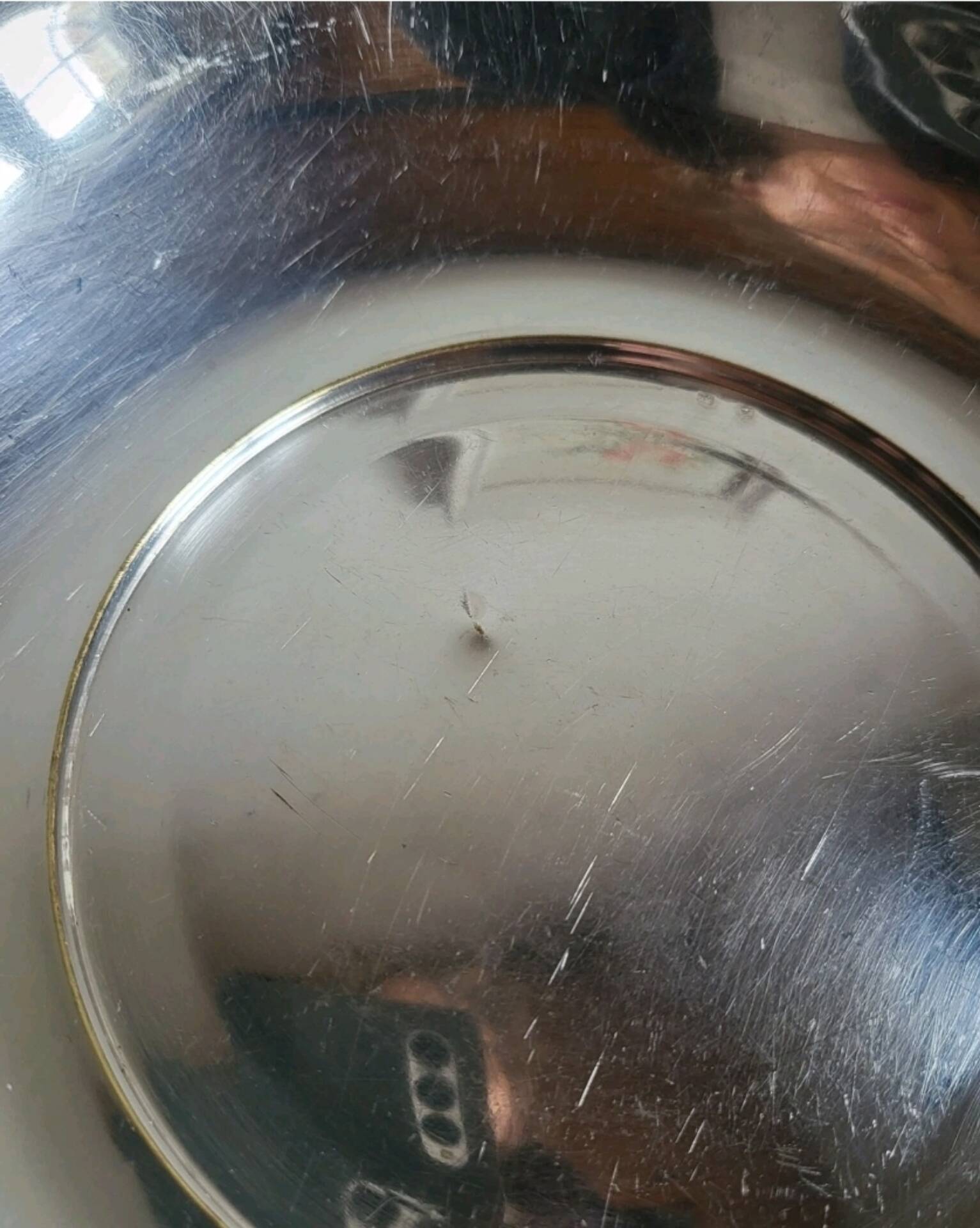 Shallow round metal plate with pearl row decoration.