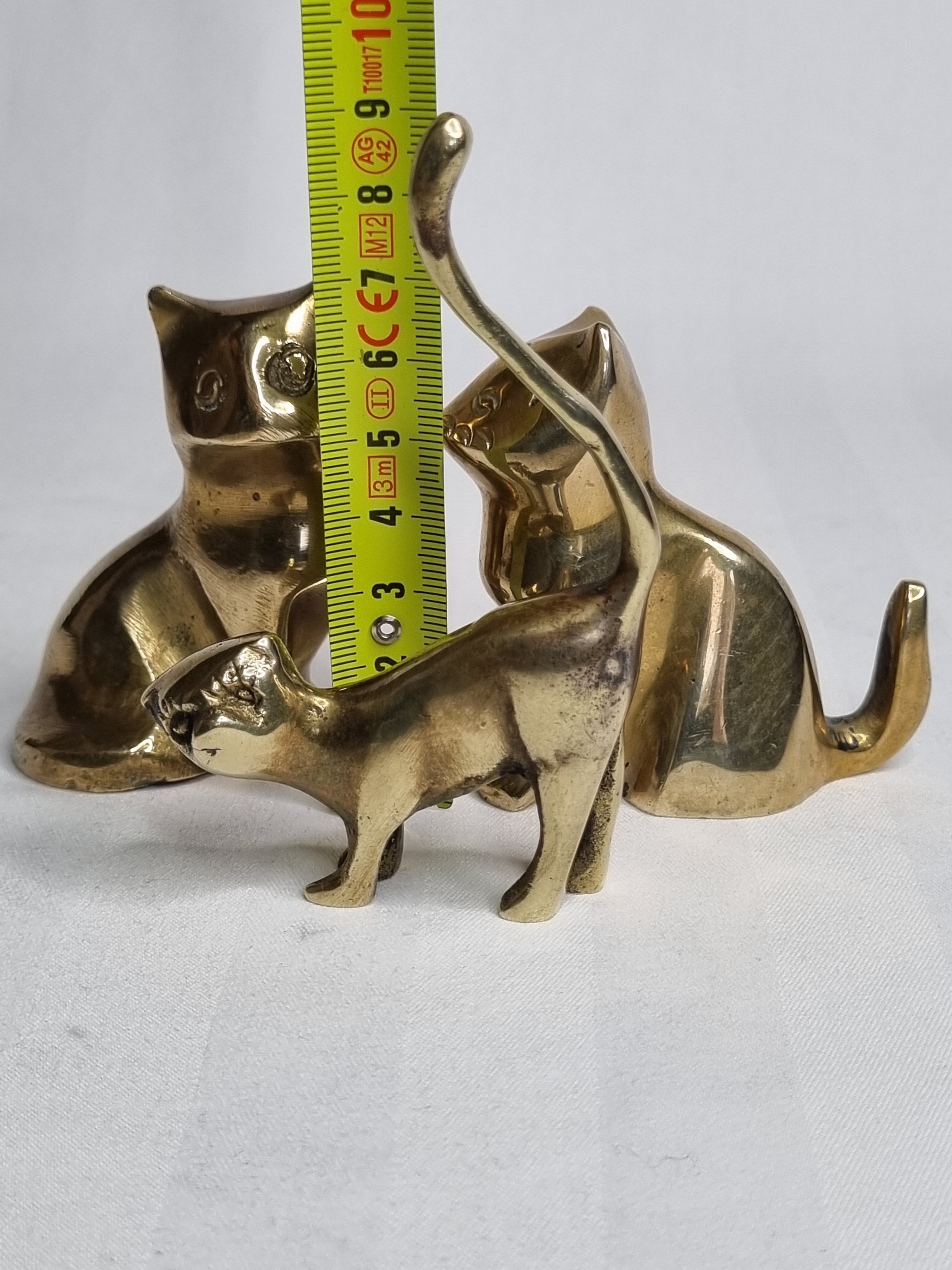 Set of three brass cats