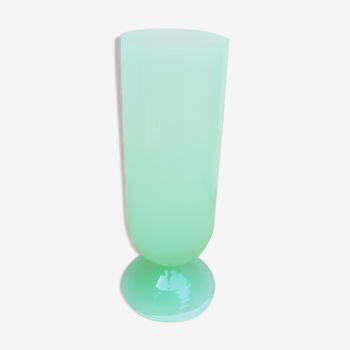 Green vase of opaque water on foot