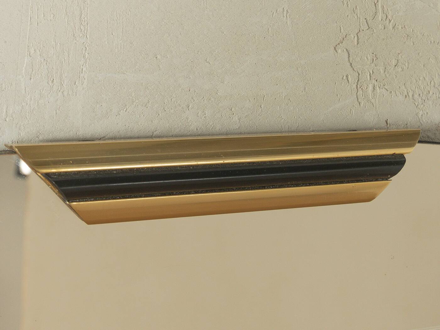 Classic 1950s mirror in black lacquered wooden frame with two brass elements