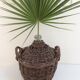 Demijohn in her braided wicker basket