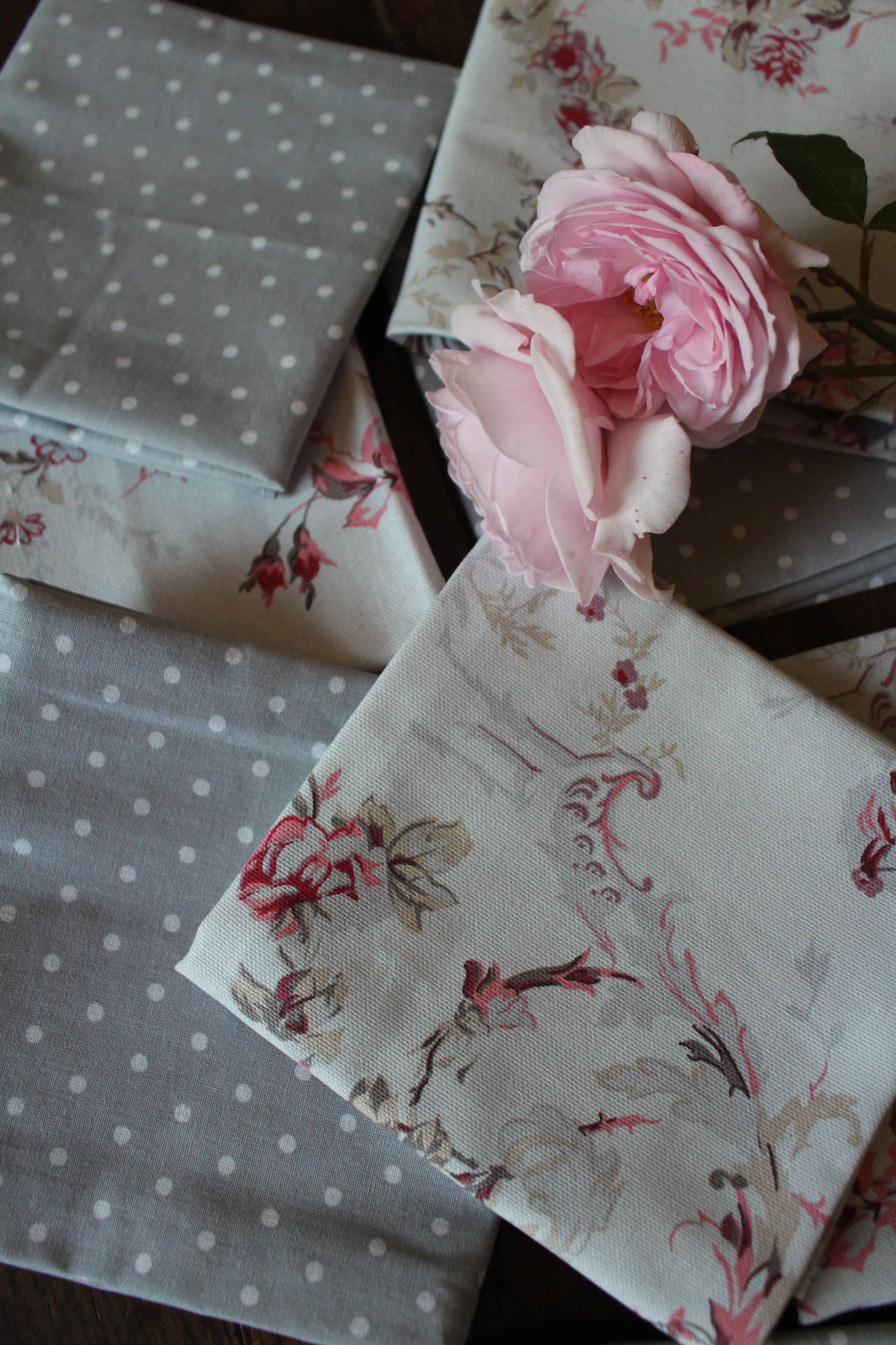 A set of 8 gray blue napkins with pink flowers and polka dots
