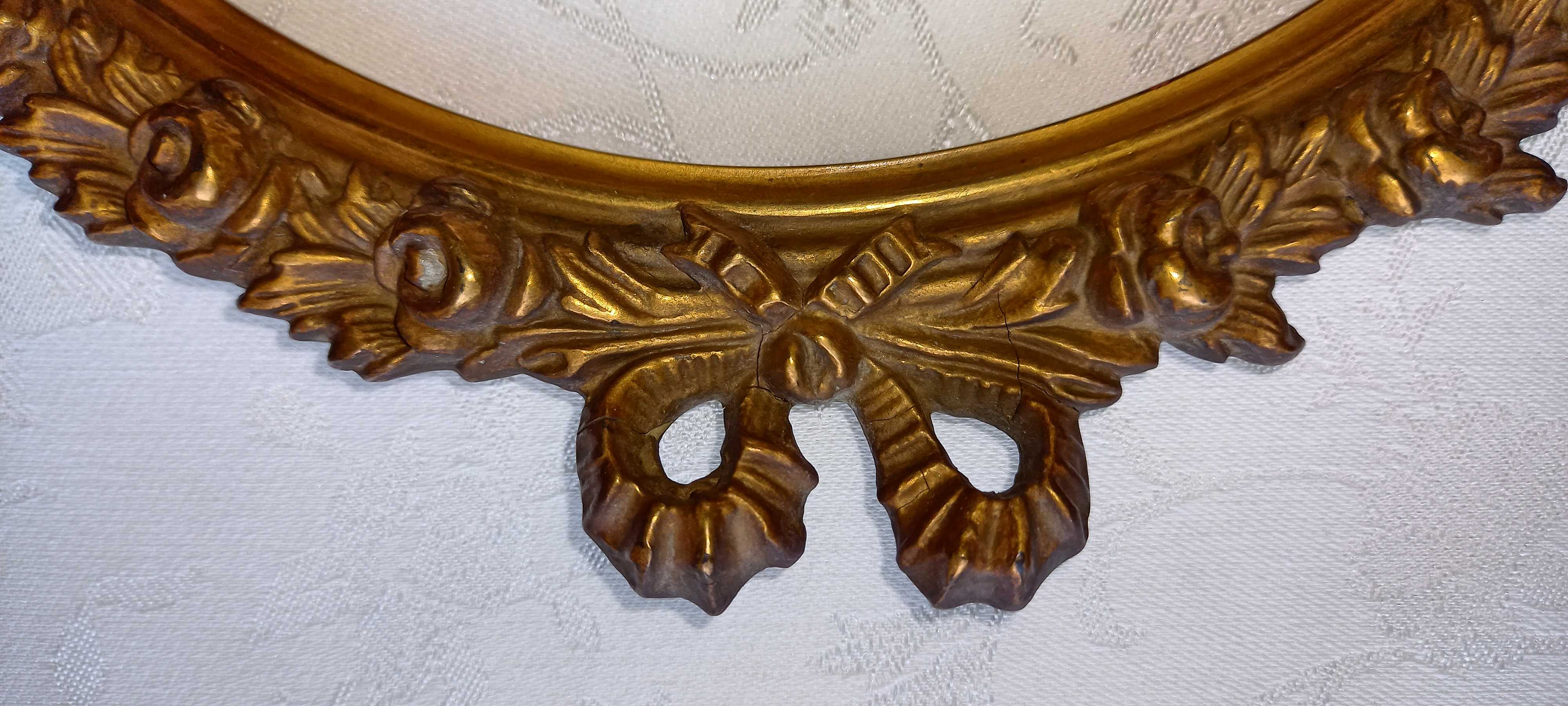 Oval frame with gilded pediments 19th wood and stucco