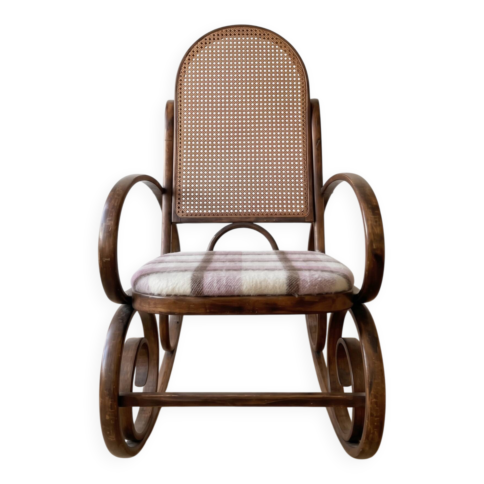 Antique rocking chair in curved wood and caning.