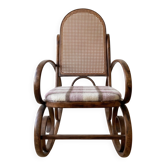 Antique rocking chair in curved wood and caning.