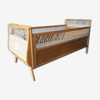 Wooden baby bed and vintage rattan