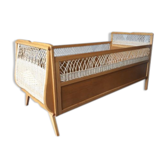 Wooden baby bed and vintage rattan