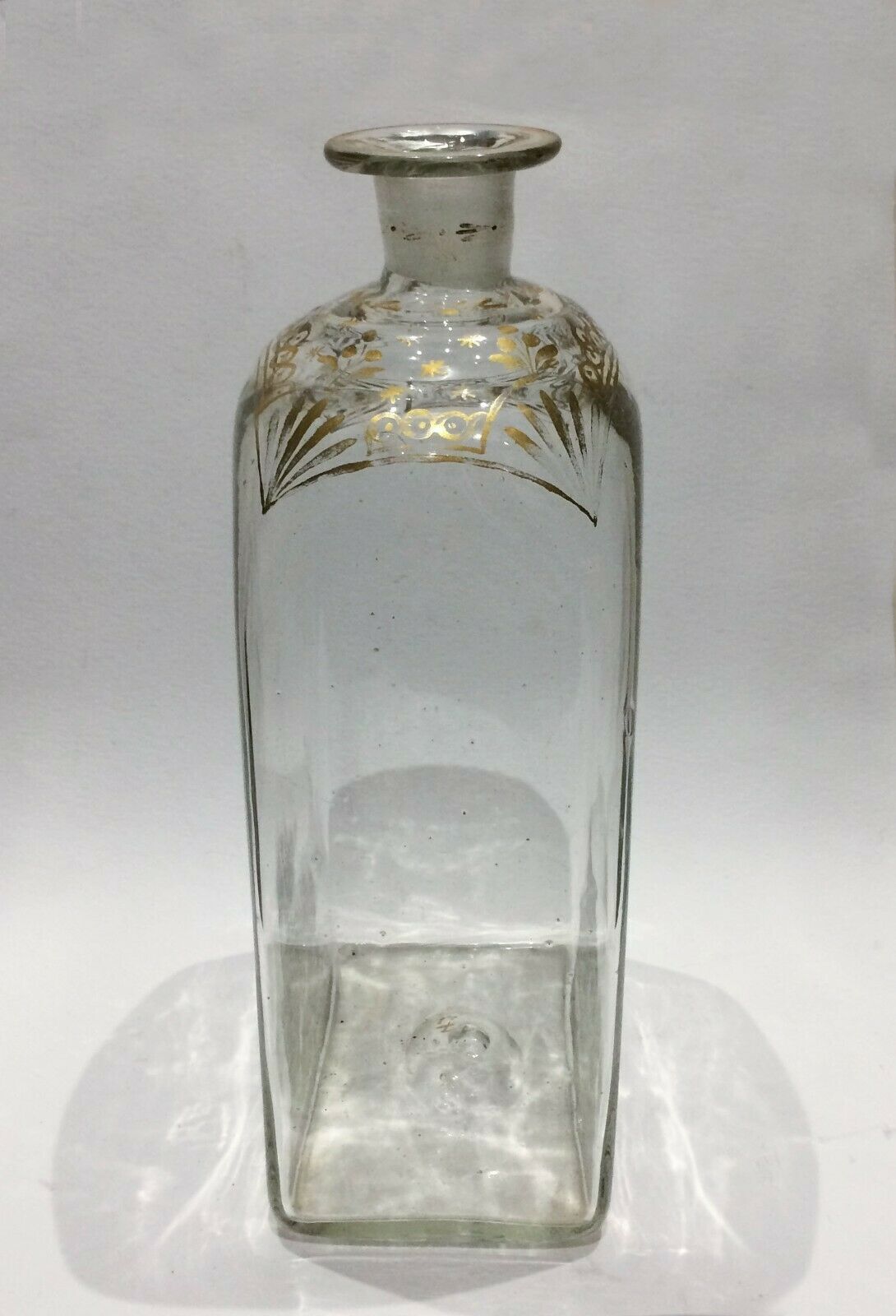 Glass bottle decorated with gold motifs
