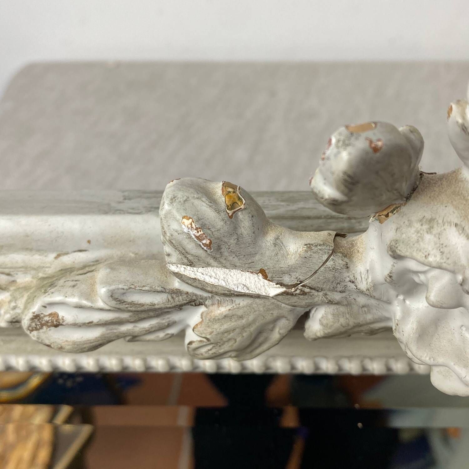 Large antique beveled mirror in carved wood painted with floral decoration and