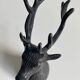 Salt and pepper shaker set with patinated brass deer heads.