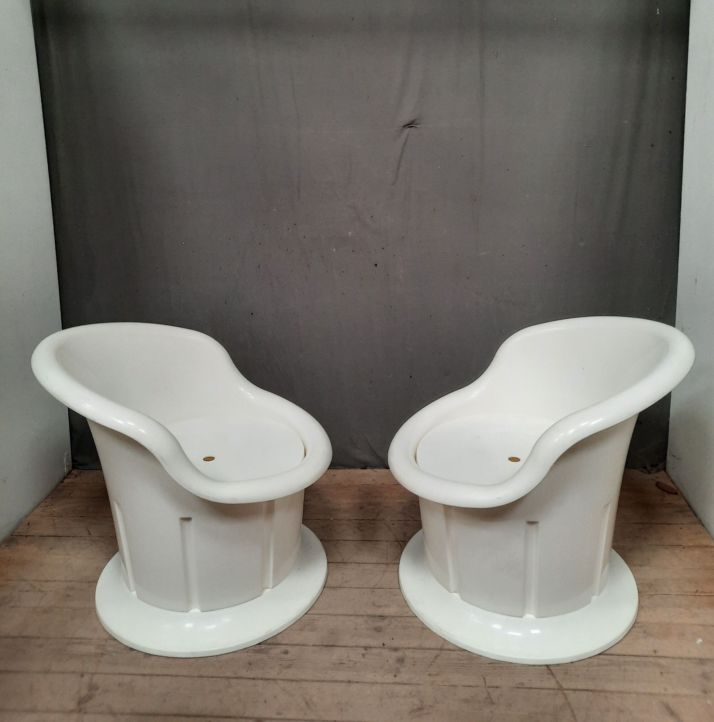 Pair of white plastic armchairs