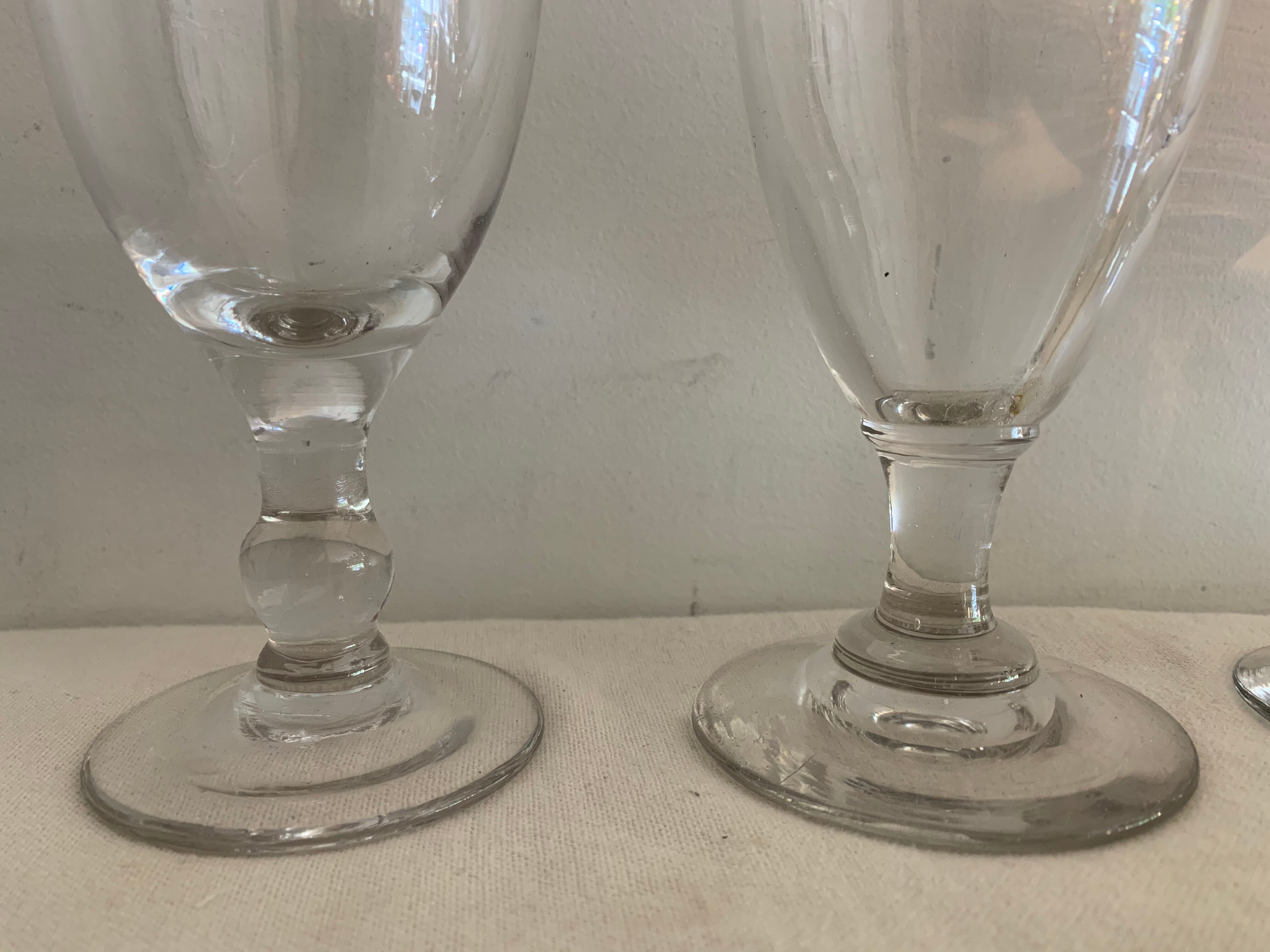 8 old blown and different foot wine glasses