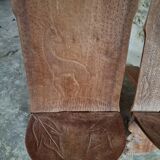Pair of hand-carved wooden folding chairs – African origin, animal and face motifs, mid-20th century