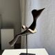 Traditional Indonesian decorative wooden bird on a base, crest model.