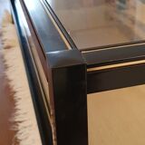 Black and gold coffee table with a double smoked glass top