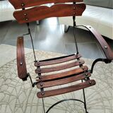 Folding garden chair with teak slats on a wrought iron structure