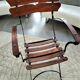 Folding garden chair with teak slats on a wrought iron structure