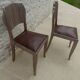 Two restyled leather-style chairs with nails