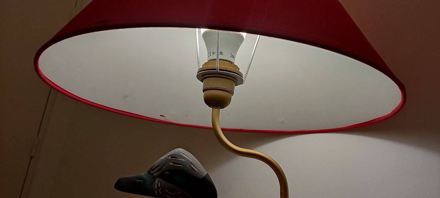 Decorative table lamp with a sculpted duck-shaped base and painted finish.