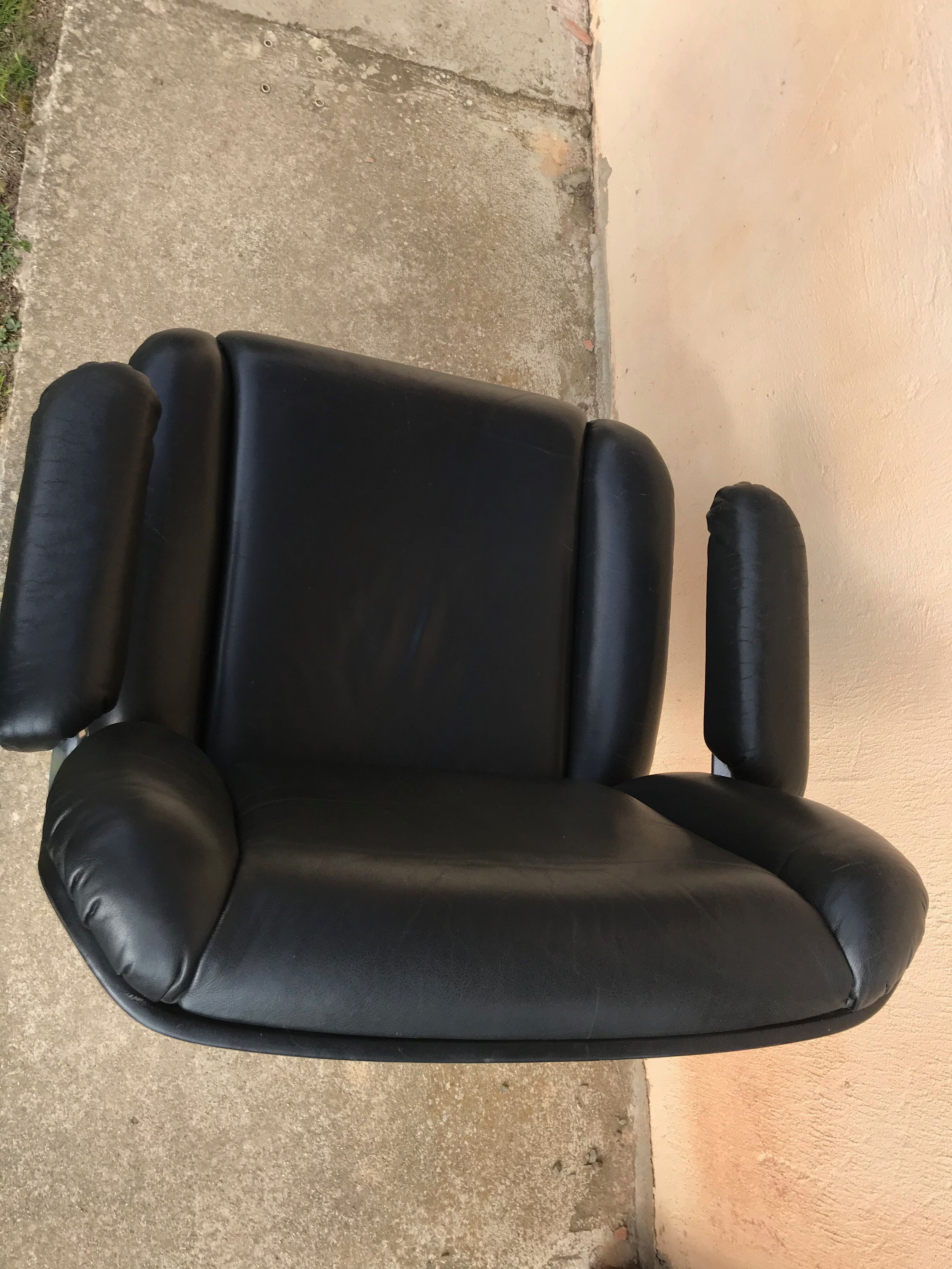 Vintage swivel black leather armchair