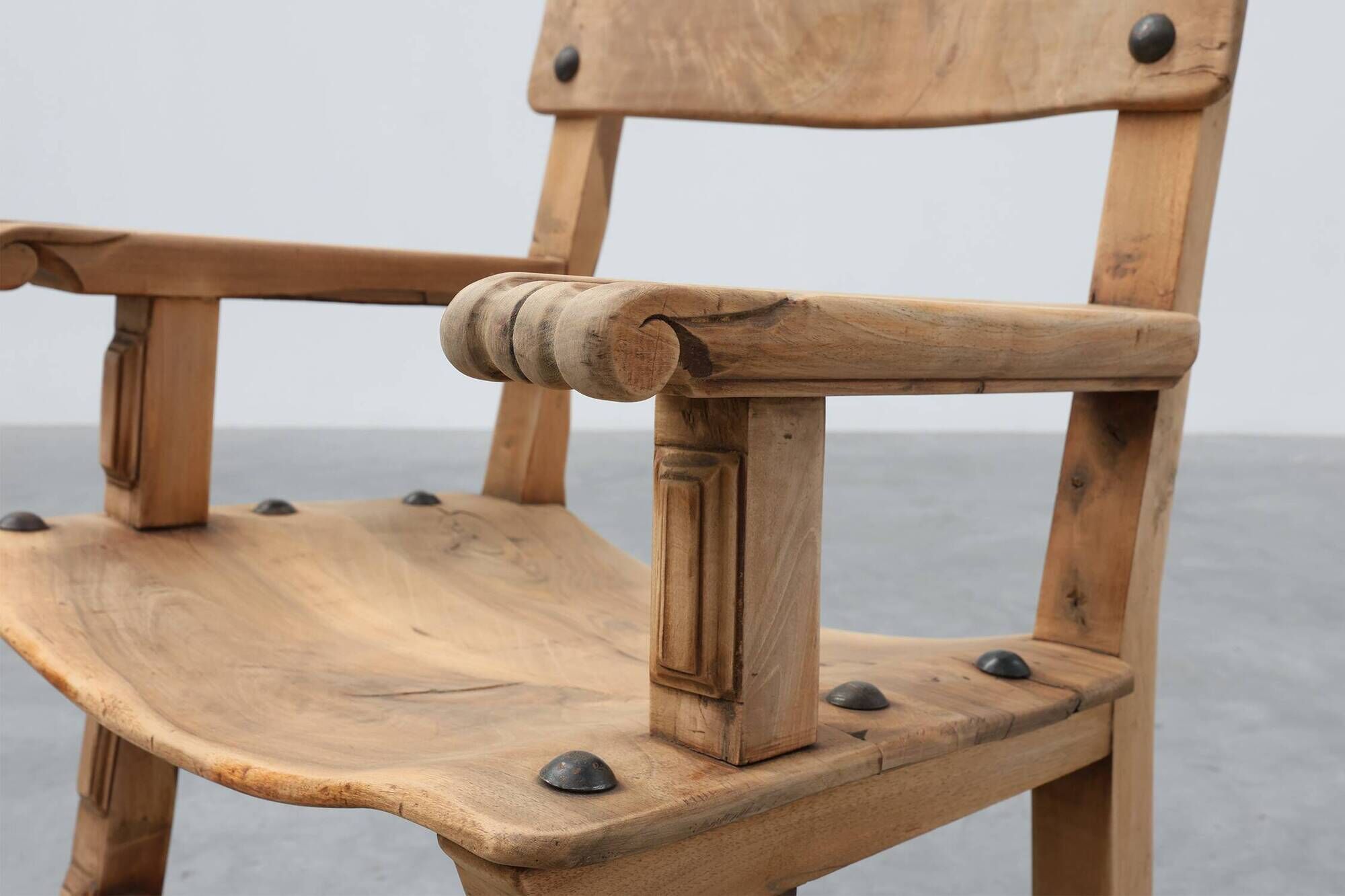 Brutalist armchair with carved rosettes and nailed wooden seat, Spain