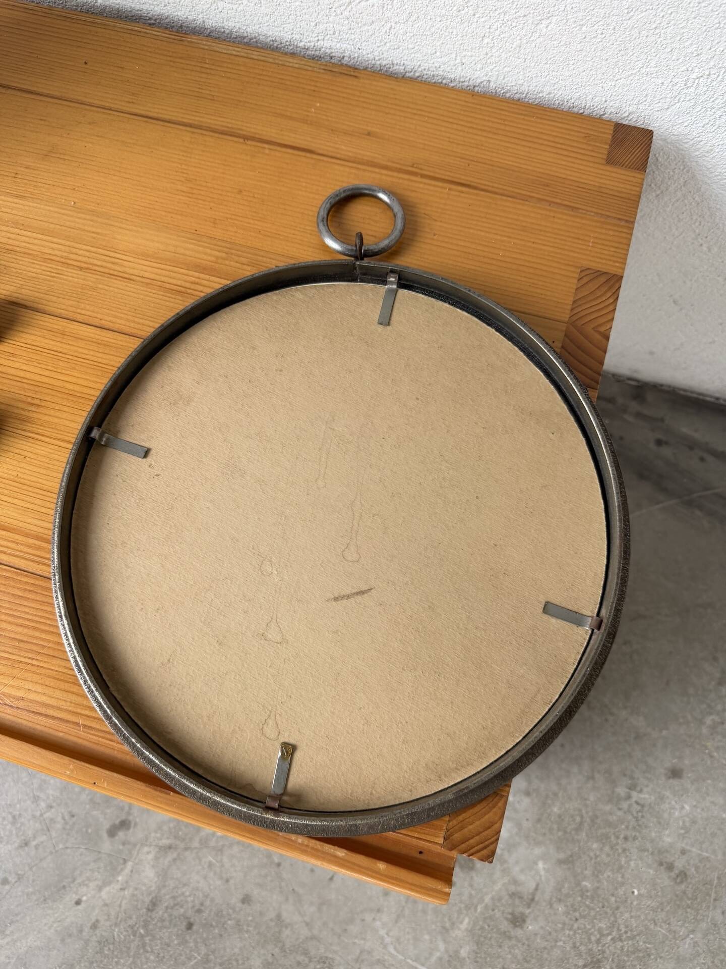 Brutalist round mirror with wrought iron and studs.