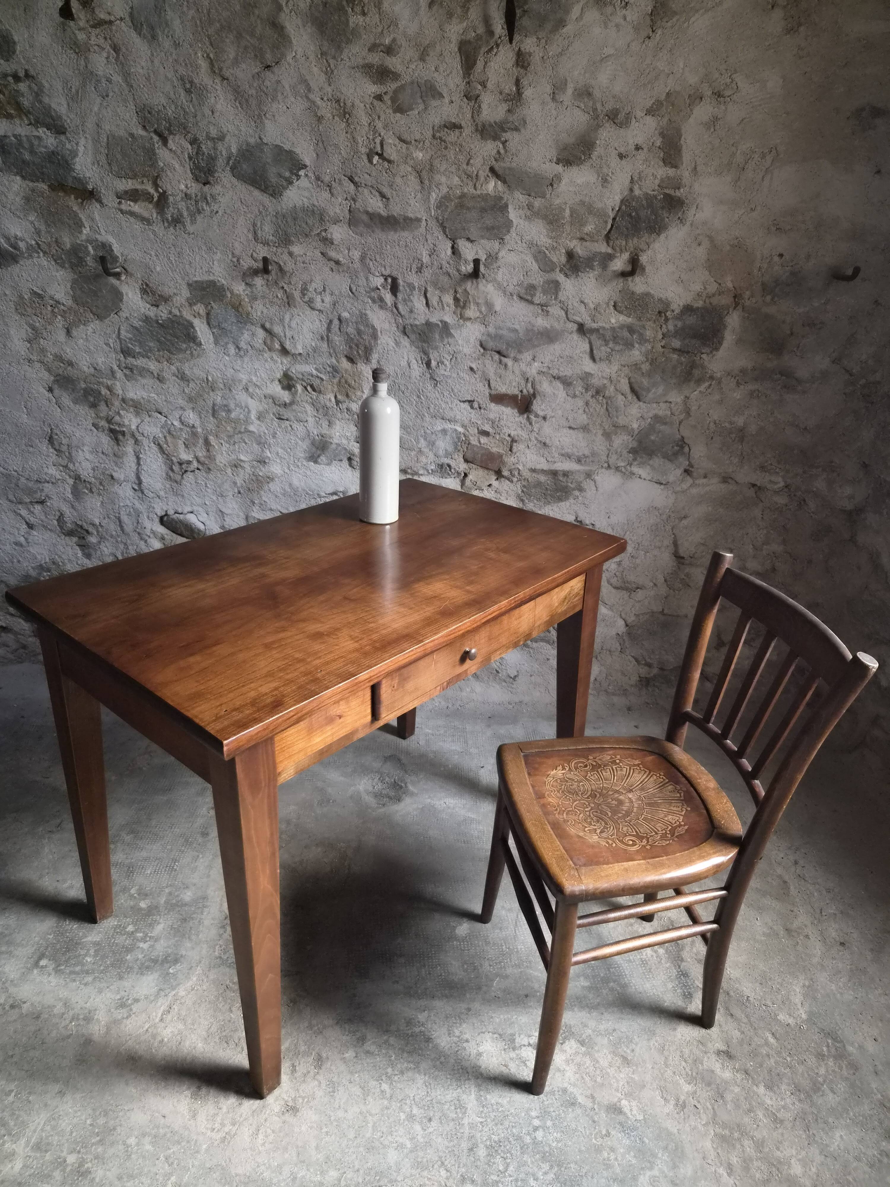 Old French table in cherry wood with bistro chair, circa 1900–1930.