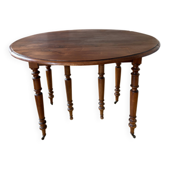 Walnut table with 6 legs and 2 extensions.