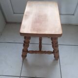 Rectangular wooden stool with 4 turned legs.