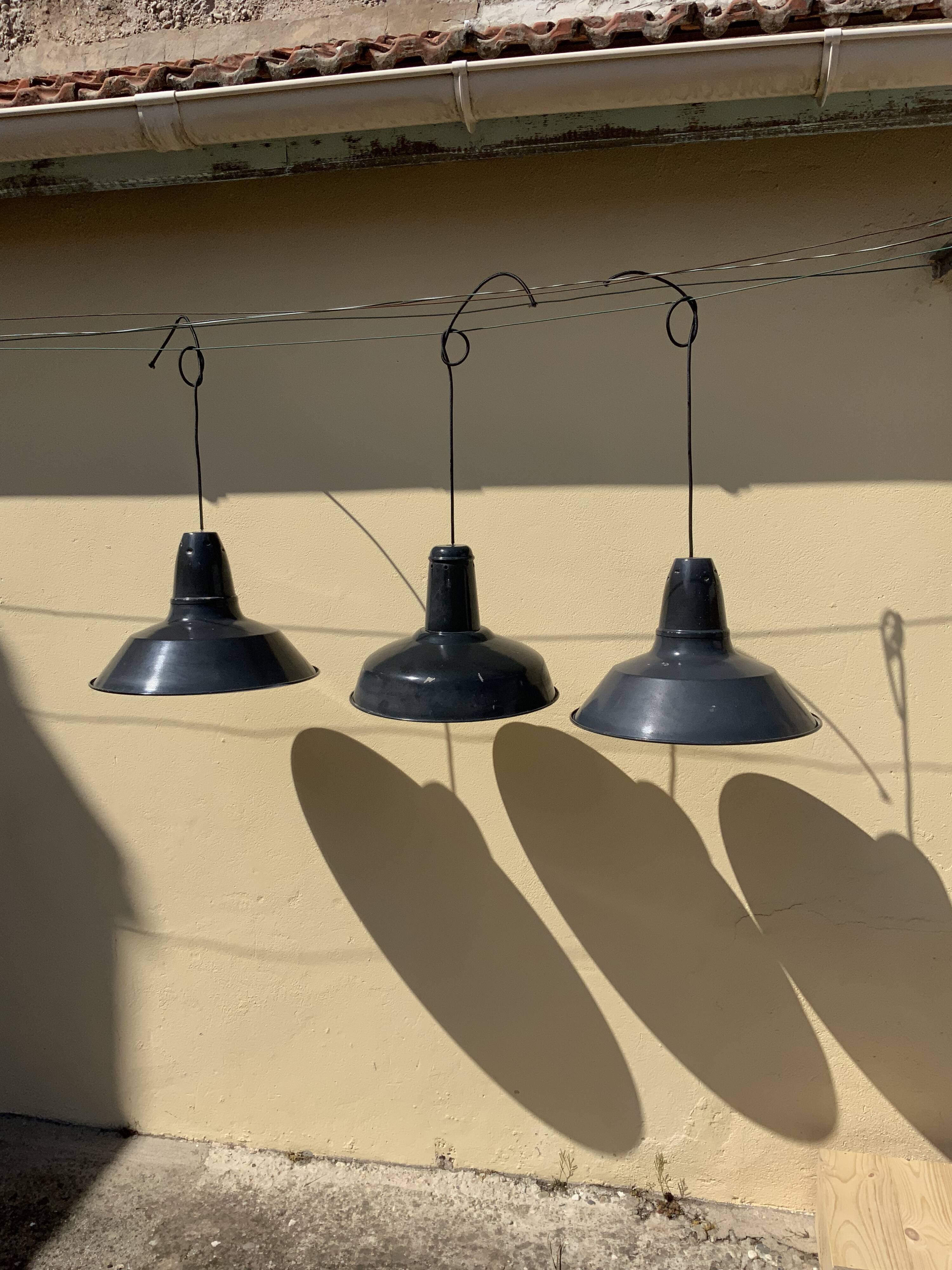 Three industrial suspensions in black and white enamelled sheet metal large format