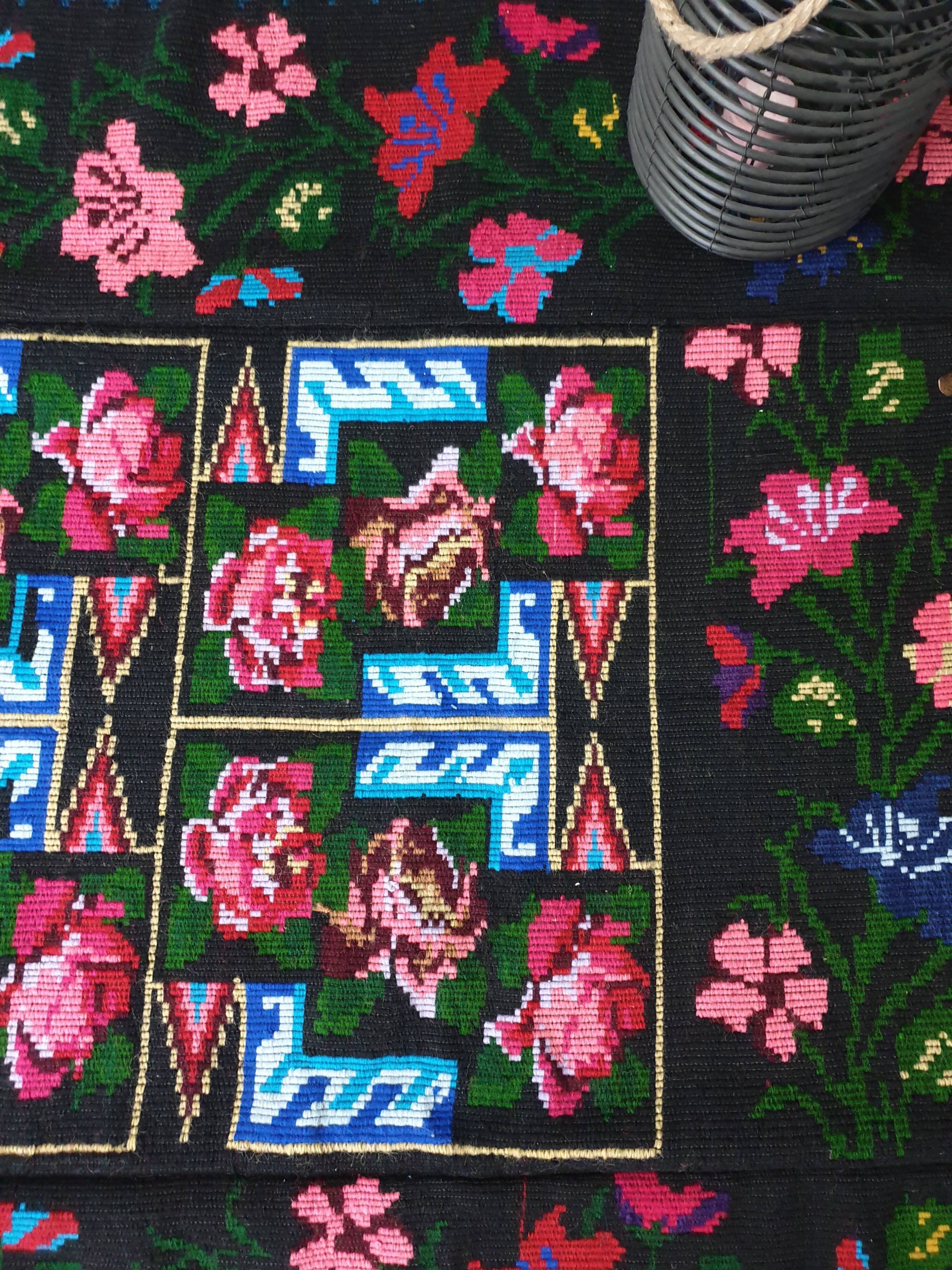 Handwoven floral wool rug, black background with pink roses and geometric design 207x144cm