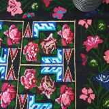 Handwoven floral wool rug, black background with pink roses and geometric design 207x144cm